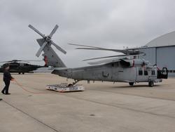 Shipboard Helo Handler moving an MH-60S helicopter.